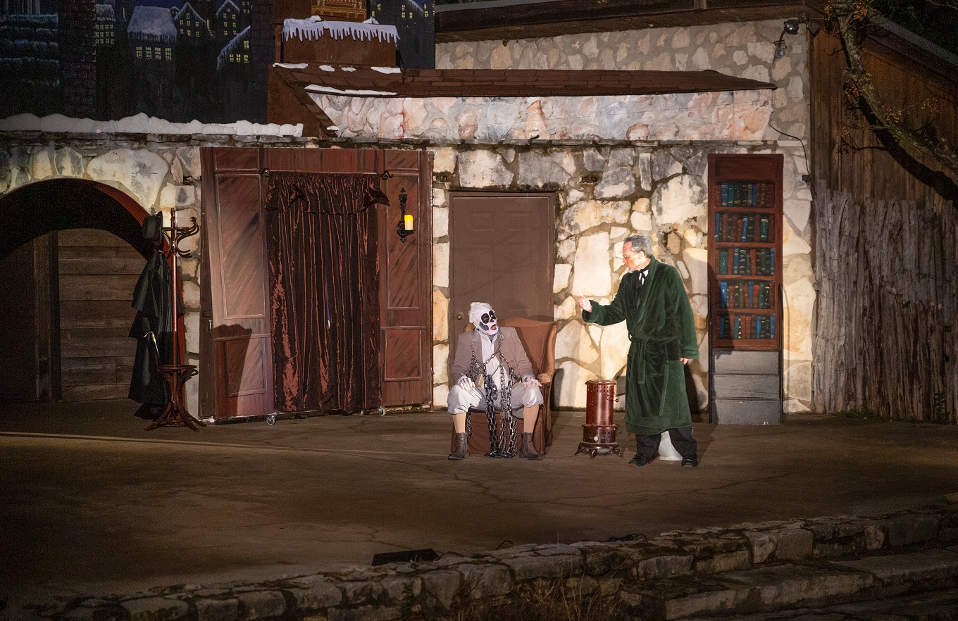 Ebenezer Scrooge is threatened by a ghost in a scene from A Christmas Carol